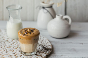Dalgona whipped coffee, instant, cream, iced coffee. Cocktail with coffee, milk and ice cubes on white background mockup. Trendy drink background with copy space for text.