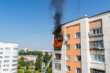 fire on the balcony of a multi-storey building, black clouds of smoke, apartment smoke,...