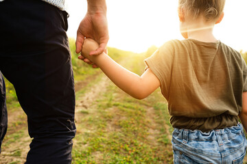 Dad taking his little daughter by the hand