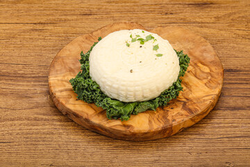 Caucasian suluguni round cheese piece