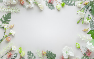 White flowers  and silver-green leaves  on pastel grey background. Flowers composition with copy...