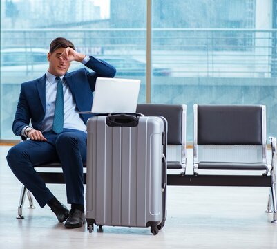 Businessman waiting at the airport for his plane in business cla