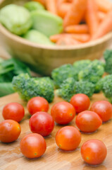 Tomato and fresh vegetables on a wooden table