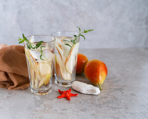 Cool summer drinks, pear cocktails with ice in glasses.