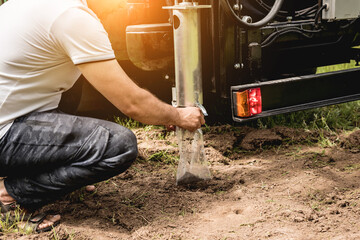 Soil examination. Collecting black soil on the field for examination