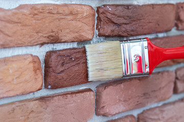 Covering of a decorative plaster tile with a protective varnish.