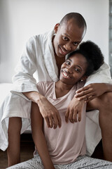 portrait of happy smiling married african couple in the morning at home, man and woman happy together, they are in love. posing at camera