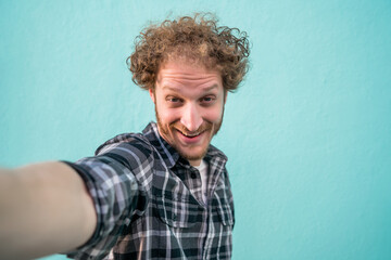 Young man taking a selfie.