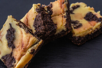 cheesecake brownie on black background