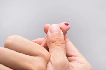 Blood drop on fingertip prepare for checking the glucose level with a glucometer for examining...