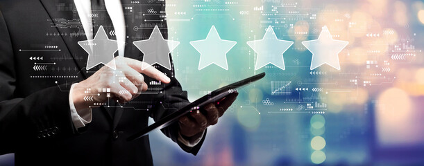 Rating star concept with businessman using his tablet computer