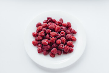 Red raspberry berries close-up on a white background. Healthy food, natural vitamins. Fresh berries