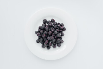 Black raspberry berries close-up on a white background. Healthy food, natural vitamins. Fresh berries