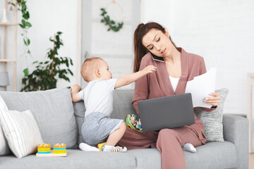 Business And Maternity. Annoyed mom trying to work while toddler distracting her