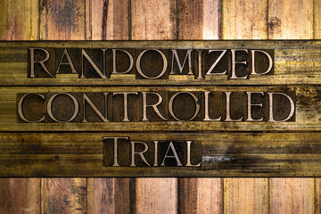 Randomized Controlled Trial text formed with real authentic typeset letters on vintage textured silver grunge copper and gold background