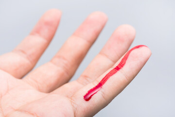 Bleeding blood from the cut finger wound. Injured finger with bleeding open cut wound. Closeup of finger human hand is cut hurt bleeding with bright red blood. 