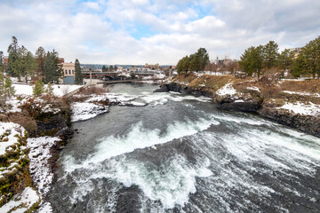 The Post Street Bridge and dam at Riverfront Park during a snowy winter day in Spokane, Washington.