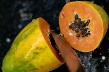 Fruits close up on black stone background