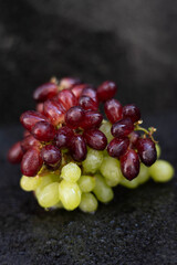 Red grapes on top of the white grapes