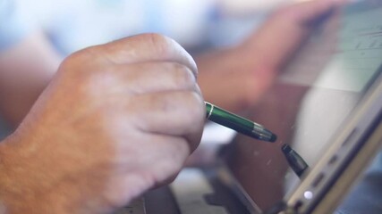 using pen for touching the digital tablet screen slow motion - Powered by Adobe