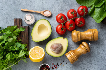 Fresh cooking ingredients and spices on concrete background. Top view. Vegan, vegetarian cooking concept