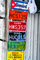 HAVANA, CUBA - NOVEMBER 17, 2017: Colorful souvenir license plates on a display. They are a popular items for sale as souvenirs and can be bought in many stores or markets in Havana, Trinidad.