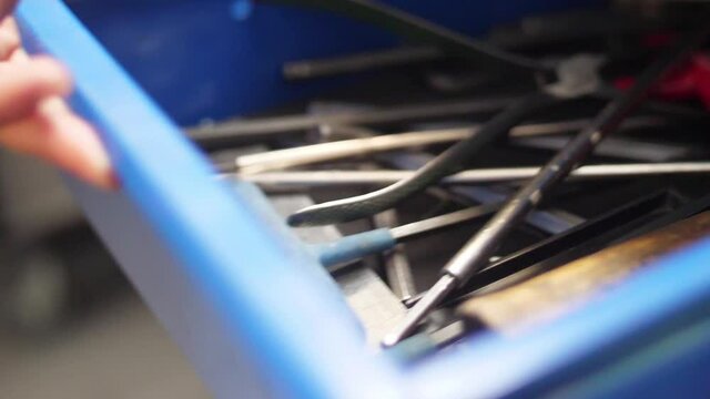 taking tool and close drawer rom storage workbench slow motion