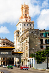 HAVANA, CUBA - NOVEMBER 14, 2017: Typical street scene with people, old cars and colorful buildings. With over 2 million inhabitants Havana is the capital of Cuba and the largest city in the Caribbean