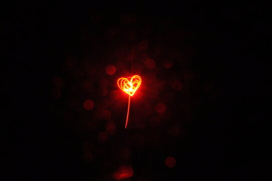 Slow shutter captures light to form a heart at night
