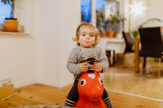 Toddler riding on toy horse