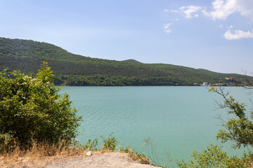 Fototapeta premium azure lake view from the cliff, in the background of the mountain with the forest