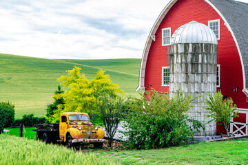 Classic red barn and orange pickup