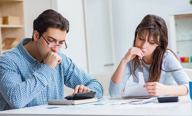 Fototapeta na wymiar Young couple looking at family finance papers
