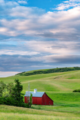 Unique red barn in rolling hills of farm country