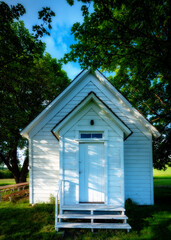 Rural back country church with trees and grass