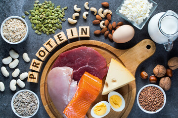 High protein food as meat, fish, dairy, eggs, buckwheat, oatmeal, nuts, bean, pumpkin seed and sunflower seed. Top view - obrazy, fototapety, plakaty