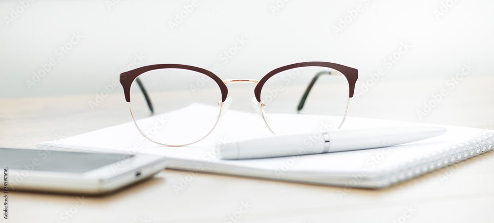 Aufkleber close-up of glasses with a notebook on the table. working space