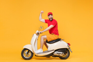 Delivery man in red cap t-shirt uniform driving moped motorbike scooter isolated on yellow...