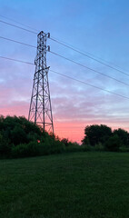 silhouette of high voltage tower pink sunrise