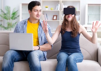 Young family playing games with virtual reality glasses