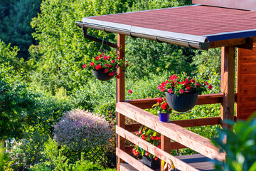 The garden wooden house decorated with summer flowers