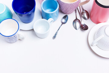 A collection of many different multi-colored mugs and tableware. Kitchen or leftover concept for a store sale