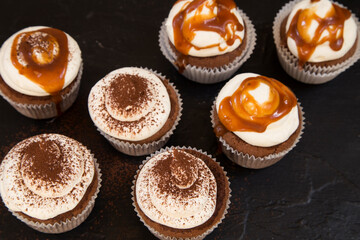 Caramel cupcakes on black background