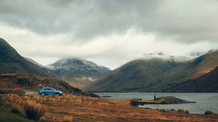 car parked in mountain landscape with lake