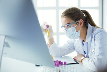 Researcher, doctor, scientist or laboratory assistant working with plastic medical tubes in modern...
