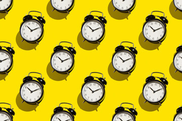 Vintage alarm clock on yellow background. Abstract pattern