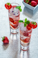 Elderflower and vodka cocktail with strawberries, tonic water and ice cubes