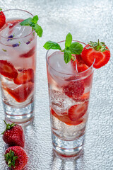 Elderflower and vodka cocktail with strawberries, tonic water and ice cubes