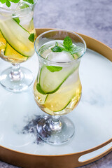 Elderflower and apple juice mocktail with cucumber, mint and ice cubes