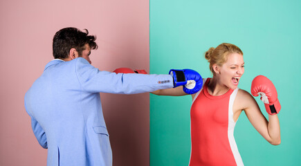 Boxers fighting in gloves. Gender equality. Man and woman boxing fight. Couple in love competing in...